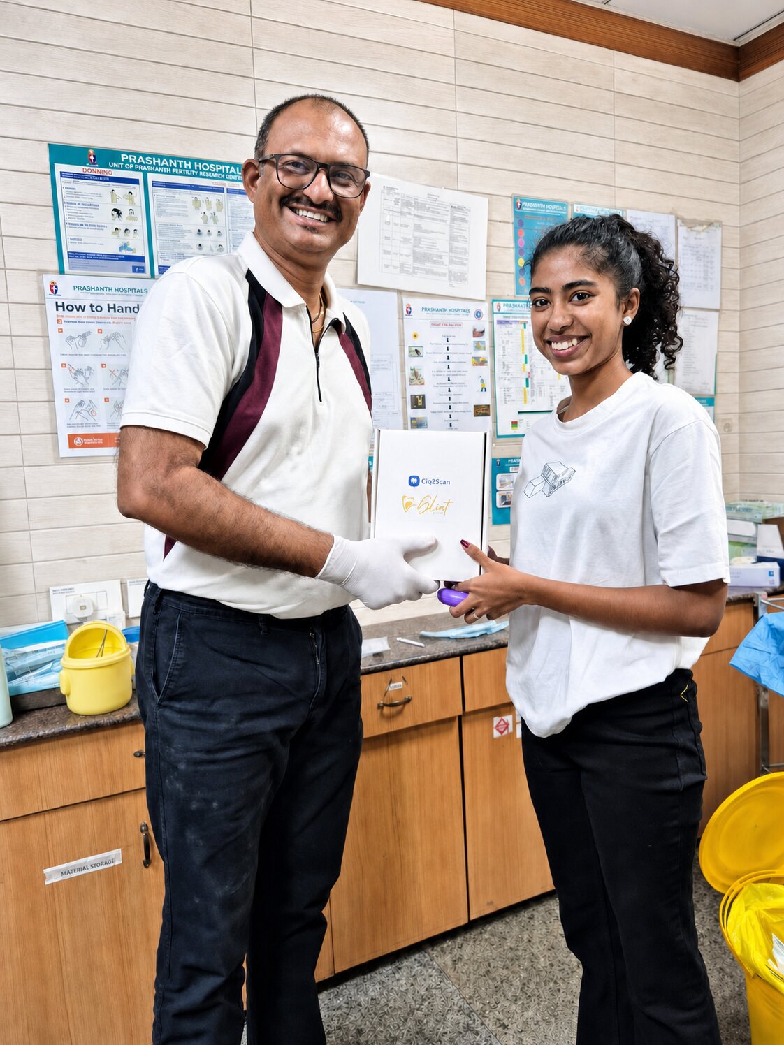 A patient at Align Dental Care receiving her scan record from the practice, both smiling to camera.