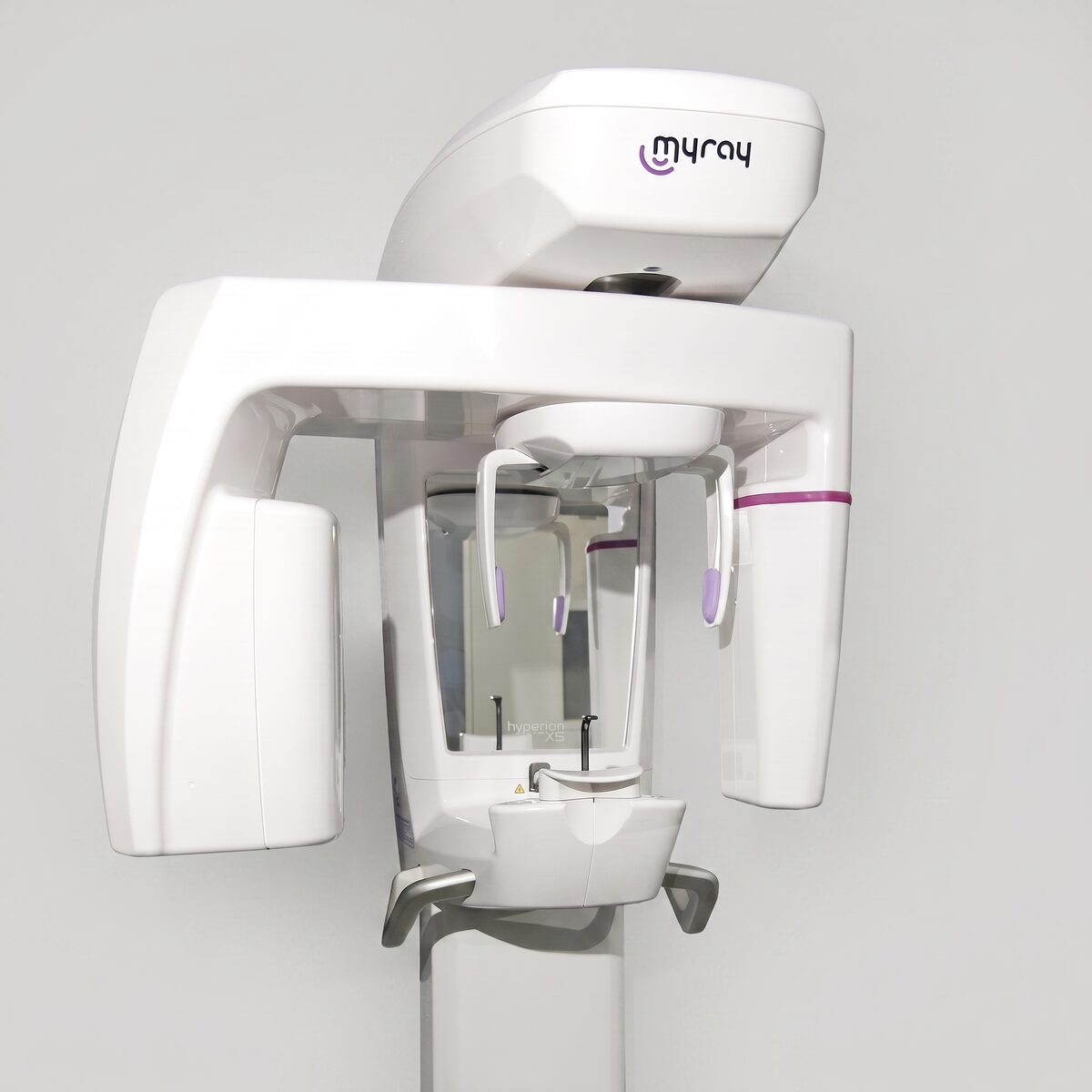 A wall-mounted panoramic dental X-ray unit, its rotating arm, chin rest and positioning guides at the centre.