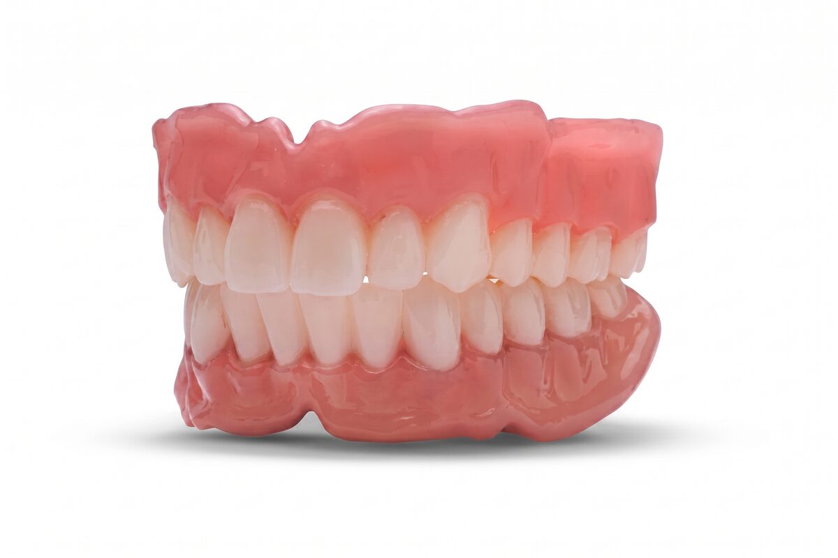 A clinical render of a complete upper and lower denture, the two arches closed together.